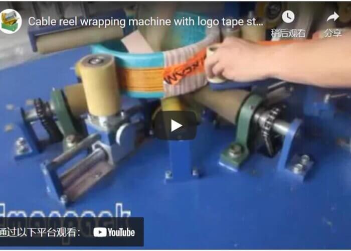 Cable reel wrapping machine with logo tape sticking mechanism