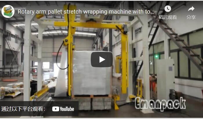 Rotary arm pallet stretch wrapping machine with top film dispenser