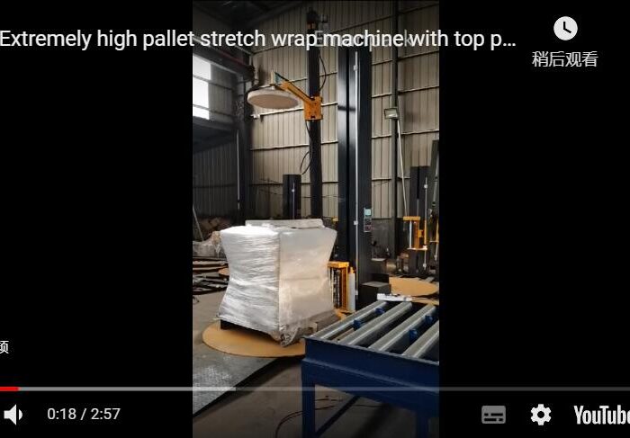 Extremely high pallet stretch wrap machine with top press platen and film cutter